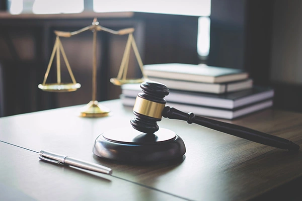 Scales of justice and Gavel on wooden table and Lawyer or Judge working with agreement in Courtroom, Justice and Law concept interpreting and translation services for police